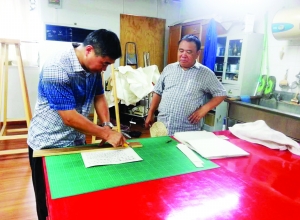 丁为新在故宫进修时，师傅李寅（右）在教他修复册页